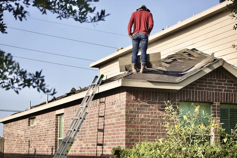 Professional roofer working on a residential roof in Mouzon